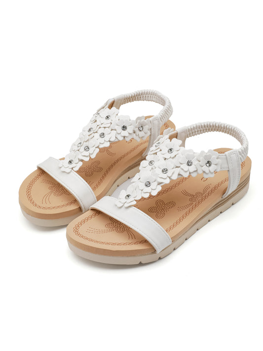 Sandali ISABAC in materiale sintetico, dettagli floreali applicati e fascette elastiche sul tallone per una calzata confortevole.

Dettagli prodotto
• Made in China
• Materiali: Vegano (Materiali sintetici)